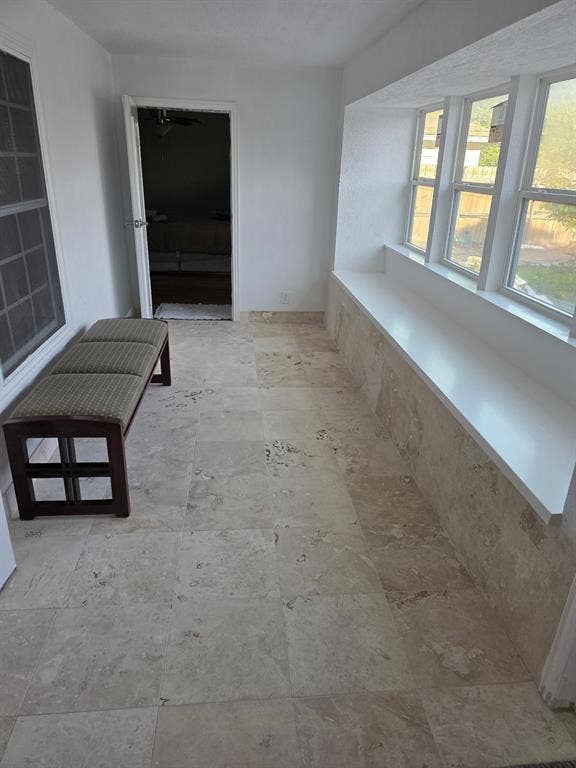 1608 University Drive, Richardson, TX 75081 Hallway featuring stone finish floor