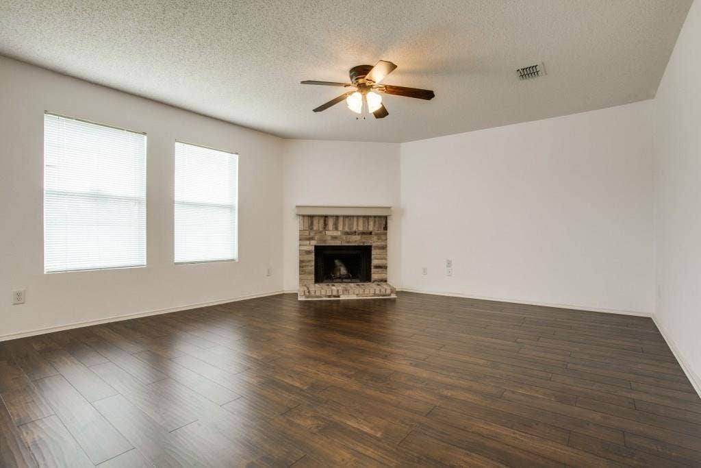 2800 Bissell Way, Wylie, TX 75098 Wood-finish flooring throughout, featuring a brick fireplace
