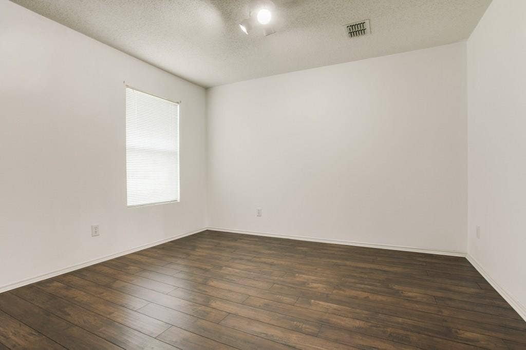2800 Bissell Way, Wylie, TX 75098 Wood-finish flooring, white walls, and a window with blinds