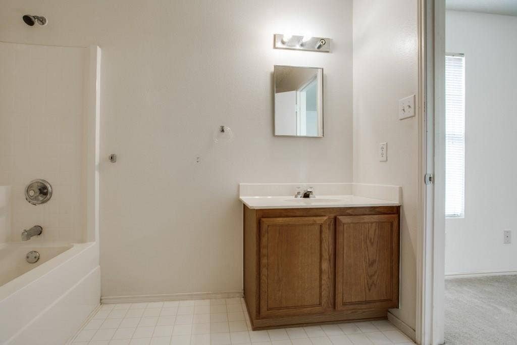 2800 Bissell Way, Wylie, TX 75098 Built-in vanity with wood-finish cabinetry, white countertop, and integrated sink