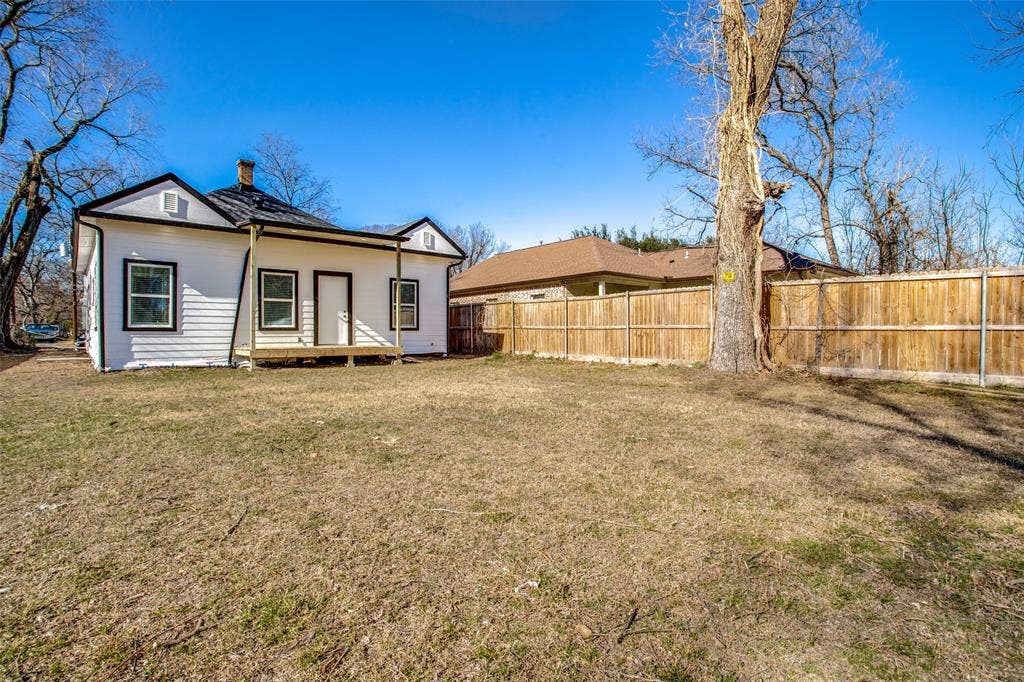 2316 Marburg Street, Dallas, TX 75215 Rear view of house with fence, a yard, and a chimney