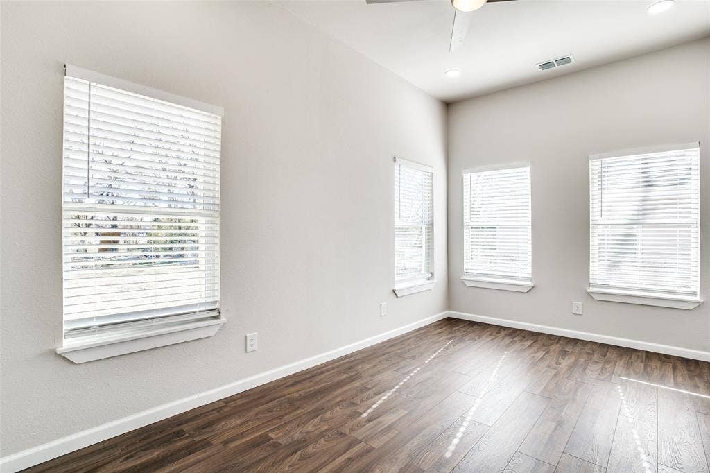 2316 Marburg Street, Dallas, TX 75215 Empty room featuring baseboards, ceiling fan, visible vents, and dark wood-type flooring