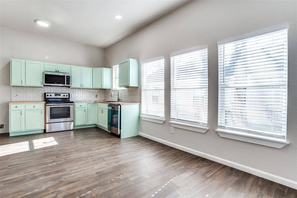 2316 Marburg Street, Dallas, TX 75215 Kitchen featuring backsplash, a sink, stainless steel appliances, and baseboards