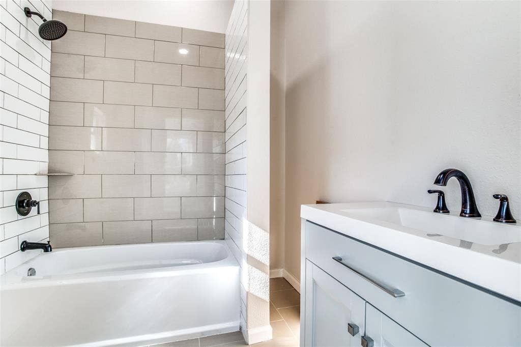 2316 Marburg Street, Dallas, TX 75215 Bathroom featuring tile patterned floors, shower / bathing tub combination, and vanity