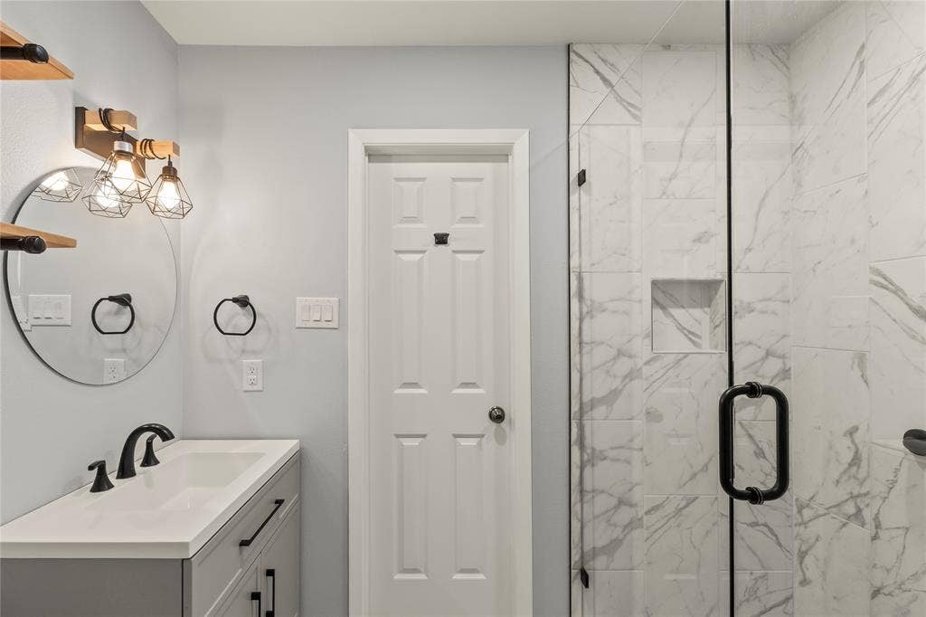 110 Henderson Harbor Circle, Payne Springs, TX 75156 Custom vanity with integrated sink, black fixtures, and round mirror