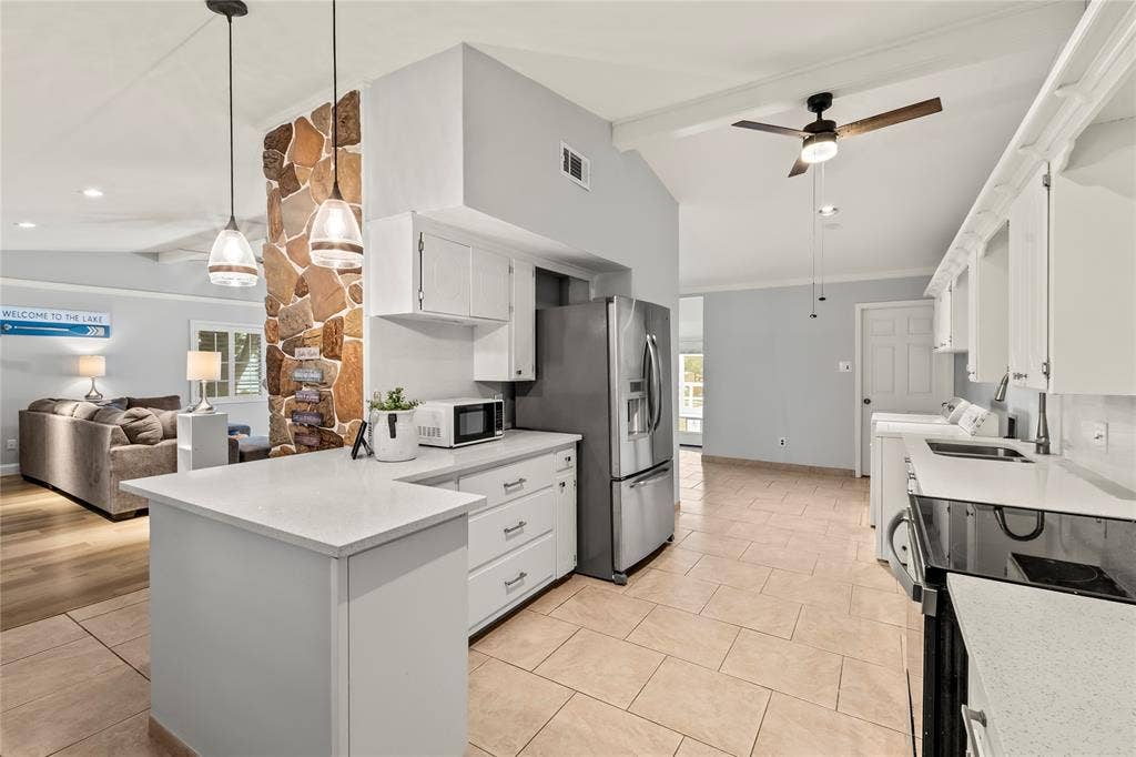 110 Henderson Harbor Circle, Payne Springs, TX 75156 Kitchen featuring white cabinetry, light-toned countertops, stainless steel appliances, and tile flooring