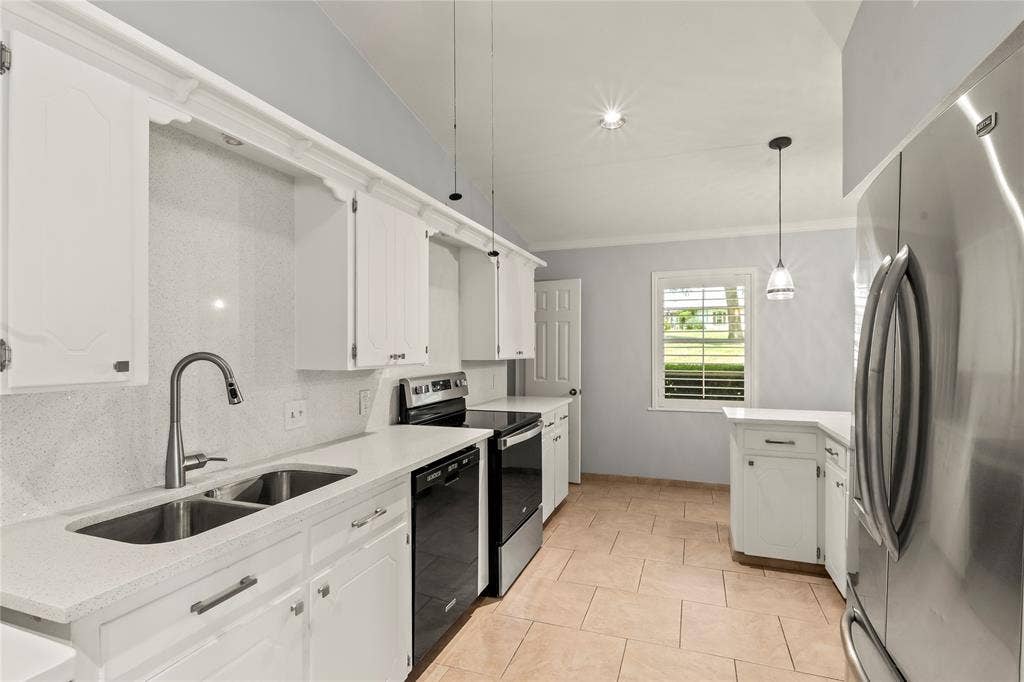 110 Henderson Harbor Circle, Payne Springs, TX 75156 White cabinetry with decorative molding, dual basin stainless steel sink with gooseneck faucet, light-toned tile flooring, and stainless steel appliances