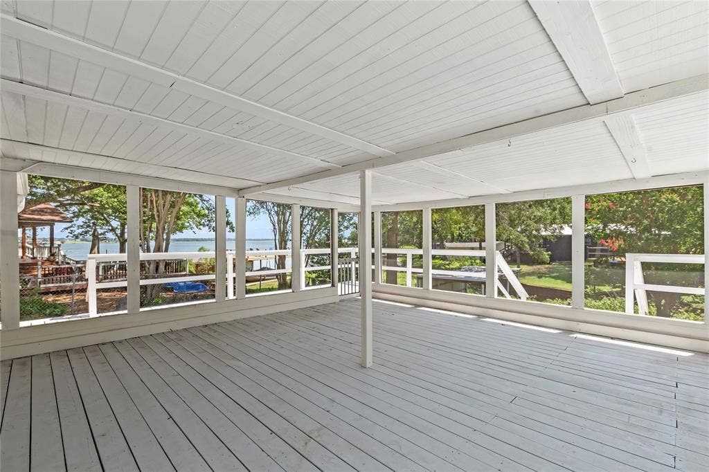 110 Henderson Harbor Circle, Payne Springs, TX 75156 Expansive screened-in porch with a wood-finish floor and white paneling