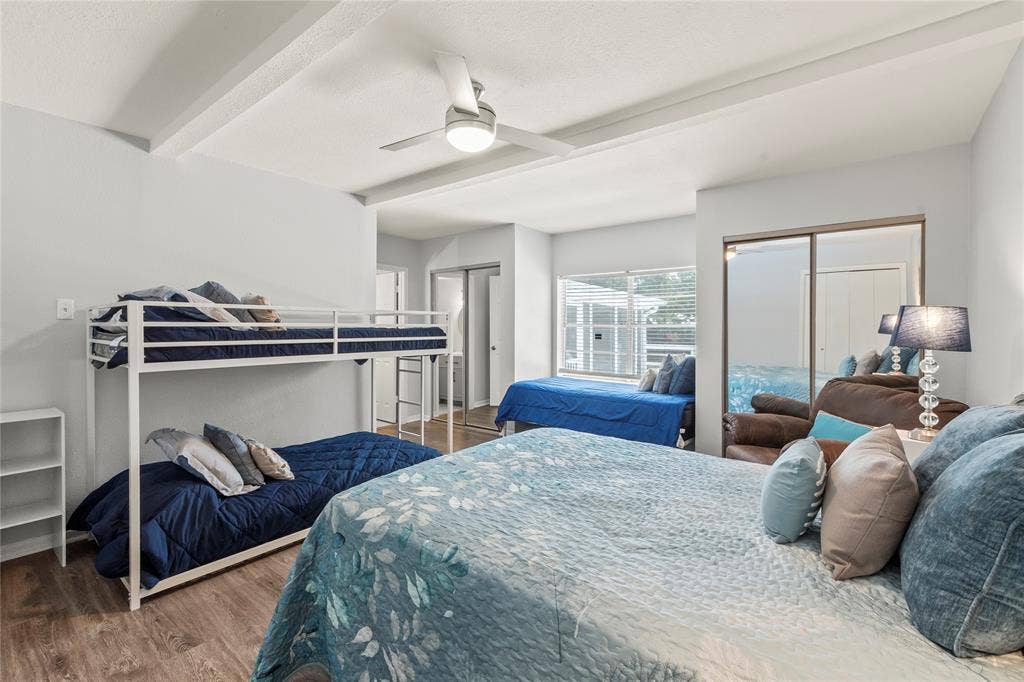 110 Henderson Harbor Circle, Payne Springs, TX 75156 Recessed ceiling with exposed beams, wood-finish flooring, ceiling fan with integrated lighting, mirrored sliding closet doors, and window with horizontal blinds