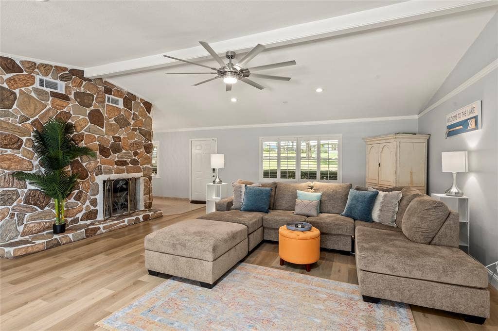 110 Henderson Harbor Circle, Payne Springs, TX 75156 Vaulted ceiling, stone-clad fireplace, wood-finish flooring, recessed lighting, and a ceiling fan