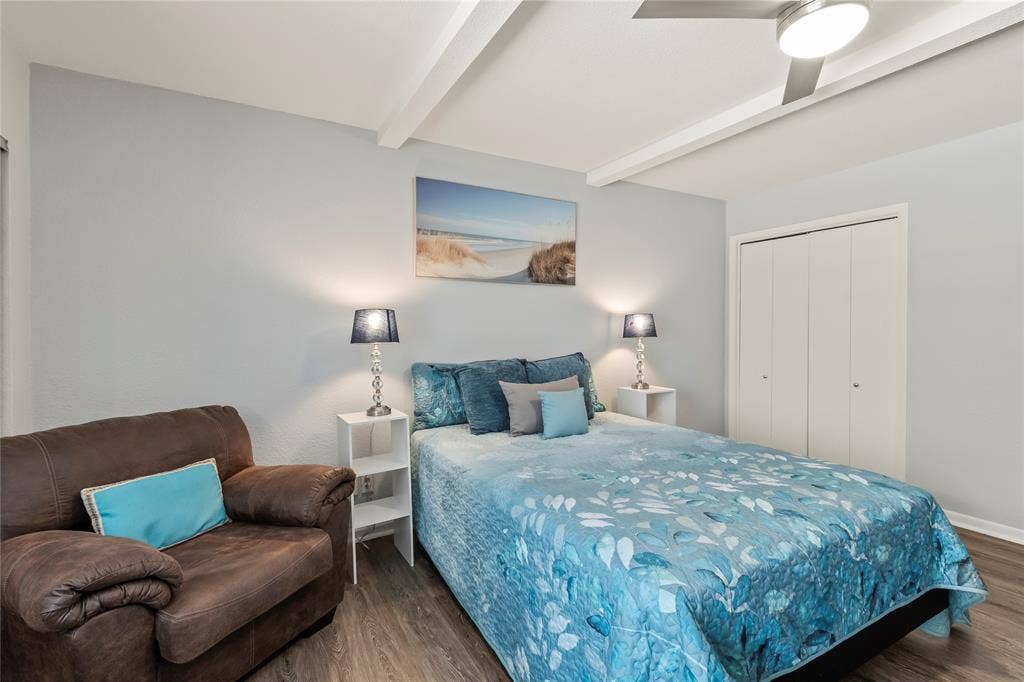 110 Henderson Harbor Circle, Payne Springs, TX 75156 Wood-finish flooring, ceiling fan, white bi-fold closet doors, and exposed ceiling beams