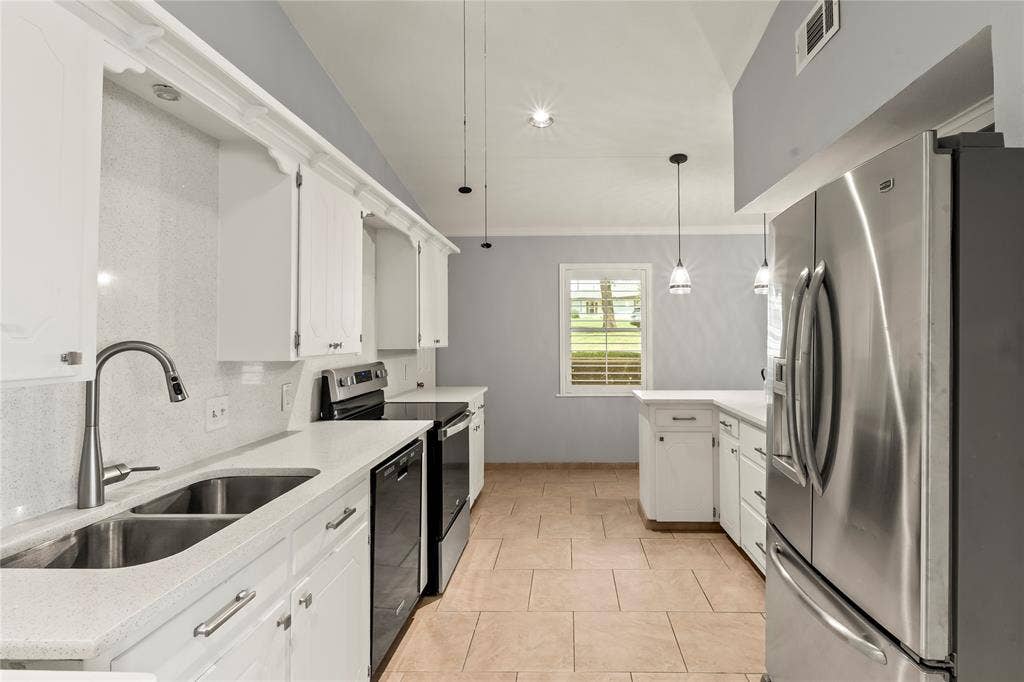 110 Henderson Harbor Circle, Payne Springs, TX 75156 Kitchen featuring white cabinetry, light-toned countertops, stainless steel appliances, and tile flooring