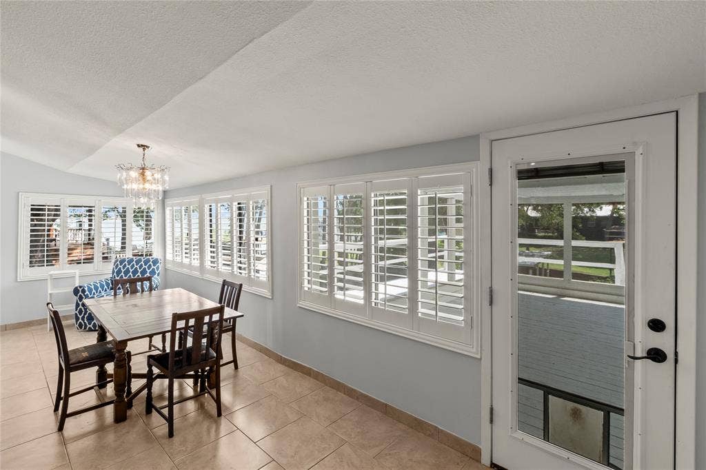 110 Henderson Harbor Circle, Payne Springs, TX 75156 Recessed ceiling, transom window, multiple windows with plantation shutters, tile flooring, and a glass-paneled door