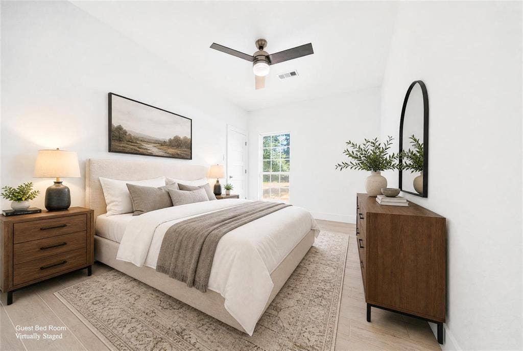 Vaulted ceiling with a ceiling fan, wood-finish flooring, and a large window