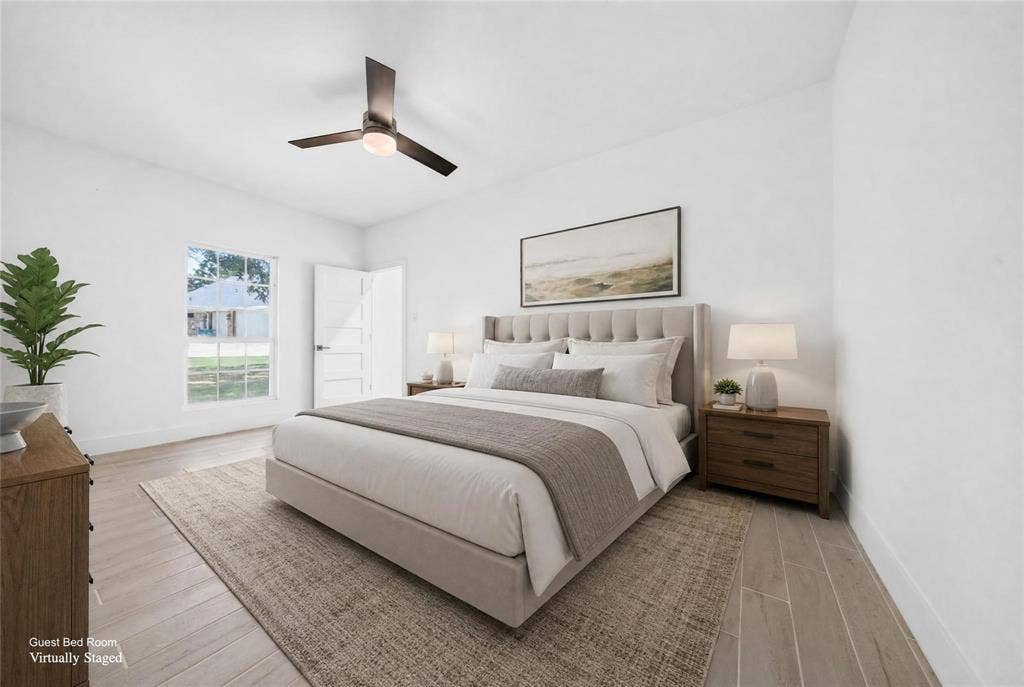 Light-filled room featuring wood-finish flooring, a contemporary ceiling fan, and a paneled door