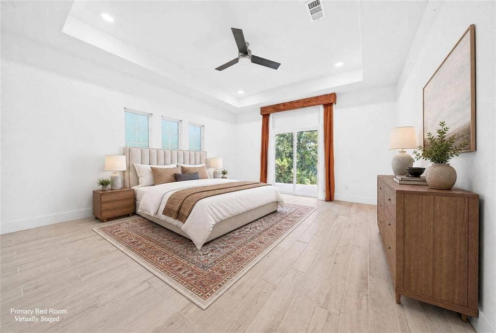 Wood-finish flooring, recessed lighting, and a tray ceiling