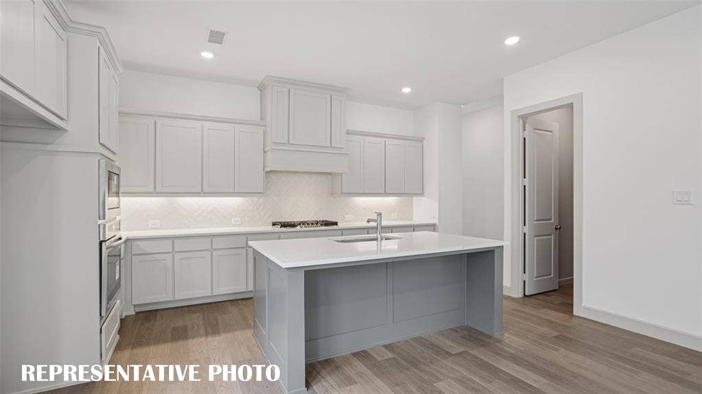 3417 Pickerel Point, McKinney, TX 75071 Your new dream home features a spacious kitchen island that is perfect for friends and family to gather round. REPRESENTATIVE PHOTO