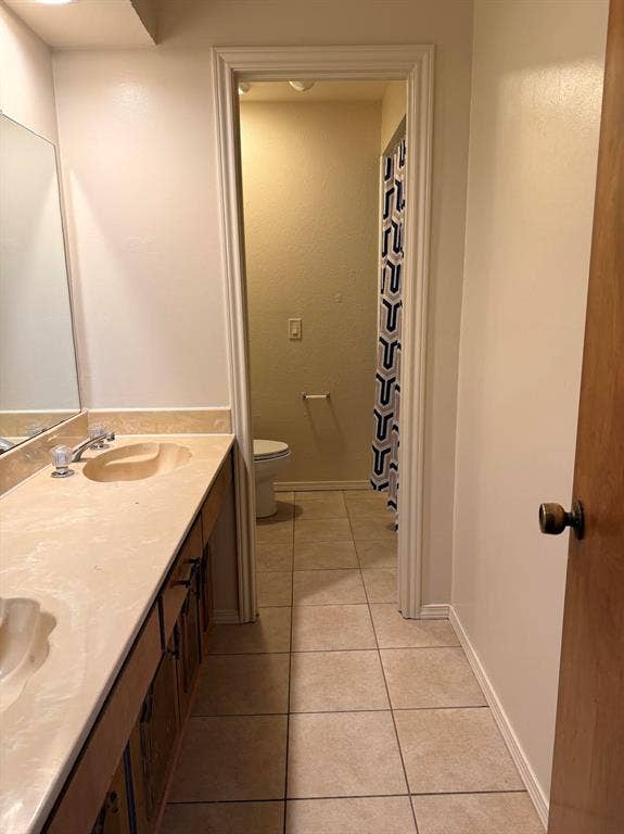 Secondary bathroom with double vanity and separate shower area.