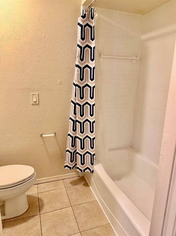 Secondary bathroom with separate shower area.