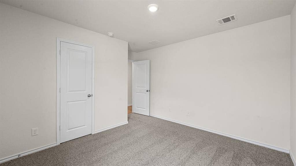 810 Parksville Drive, Ferris, TX 75125 Neutral wall paint with carpet flooring