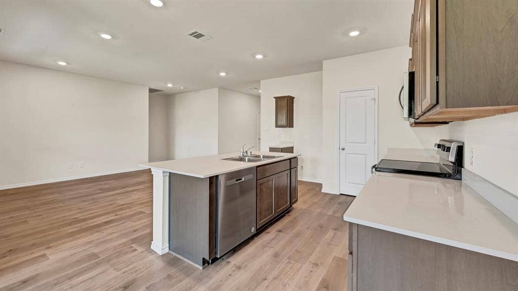 231 Yates Street, Bullard, TX 75757 Kitchen island with stainless steel dishwasher and undermount sink