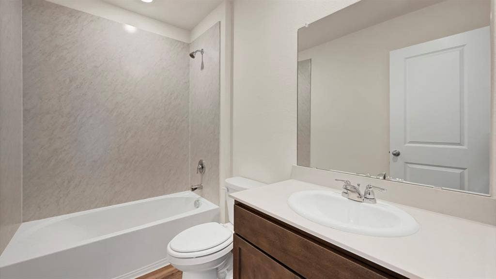 231 Yates Street, Bullard, TX 75757 Modern bathroom featuring a white bathtub with a shower and a single vanity with a white countertop