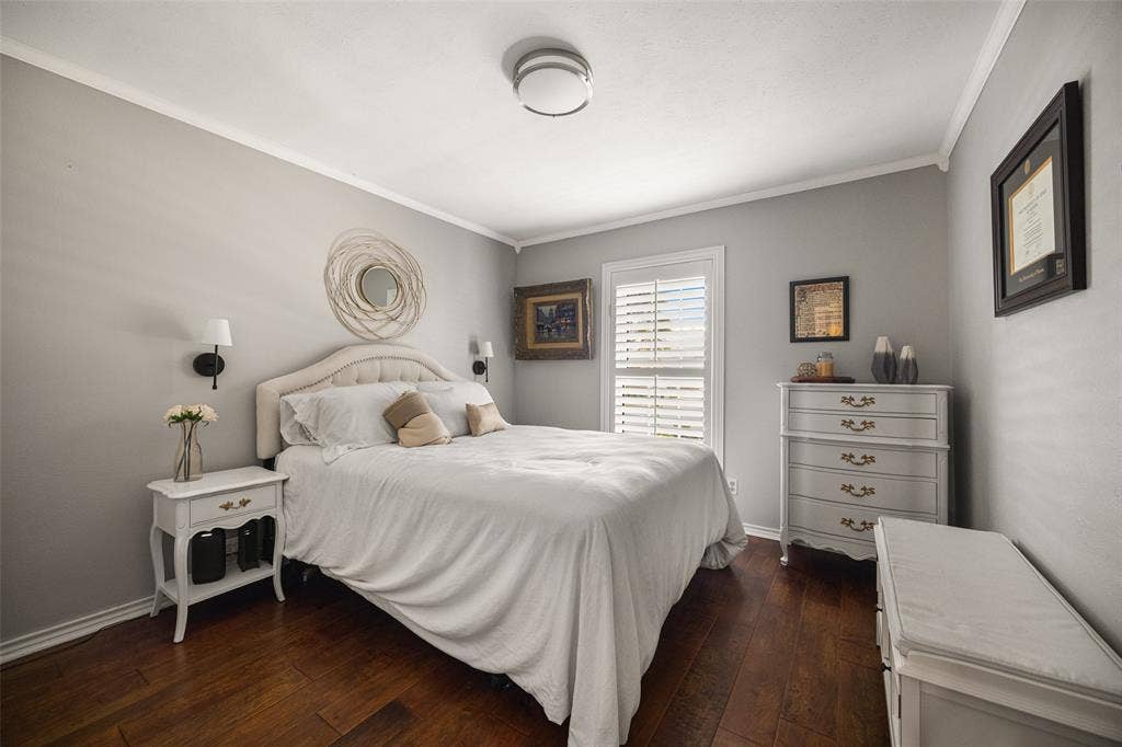 10945 Middle Knoll Drive, Dallas, TX 75238 Wood-finish flooring, neutral wall color, crown molding, plantation shutters, and a ceiling-mounted light fixture