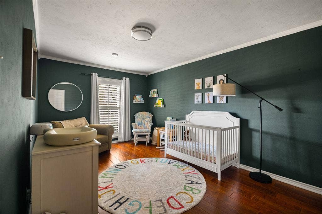 10945 Middle Knoll Drive, Dallas, TX 75238 Hardwood flooring, painted walls, white crown molding, recessed lighting, and a flush-mount ceiling light