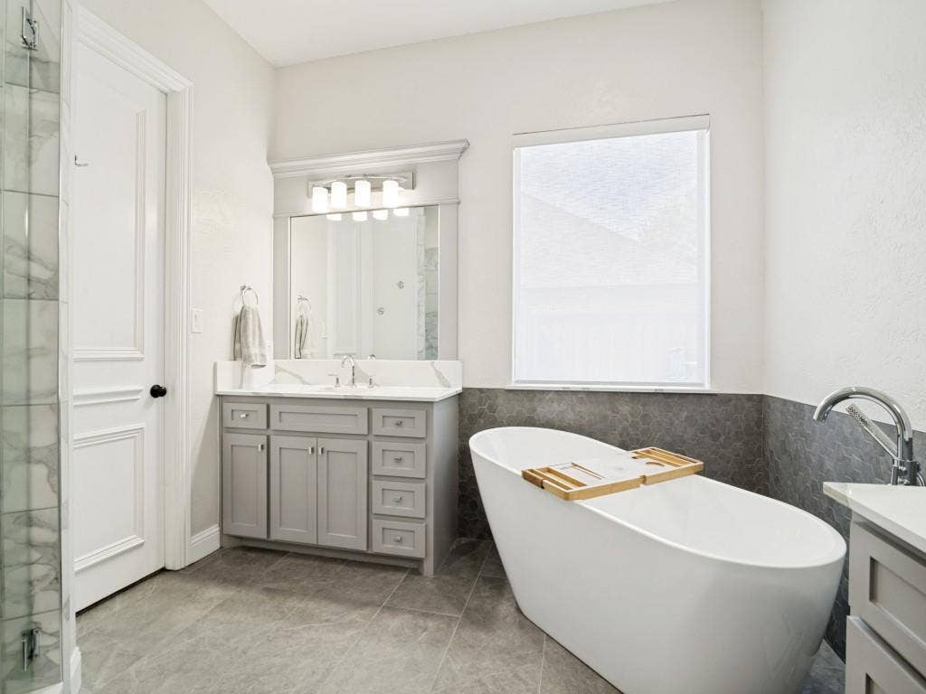 Second vanity in the primary bath with a soaking tub and walk-in closet.