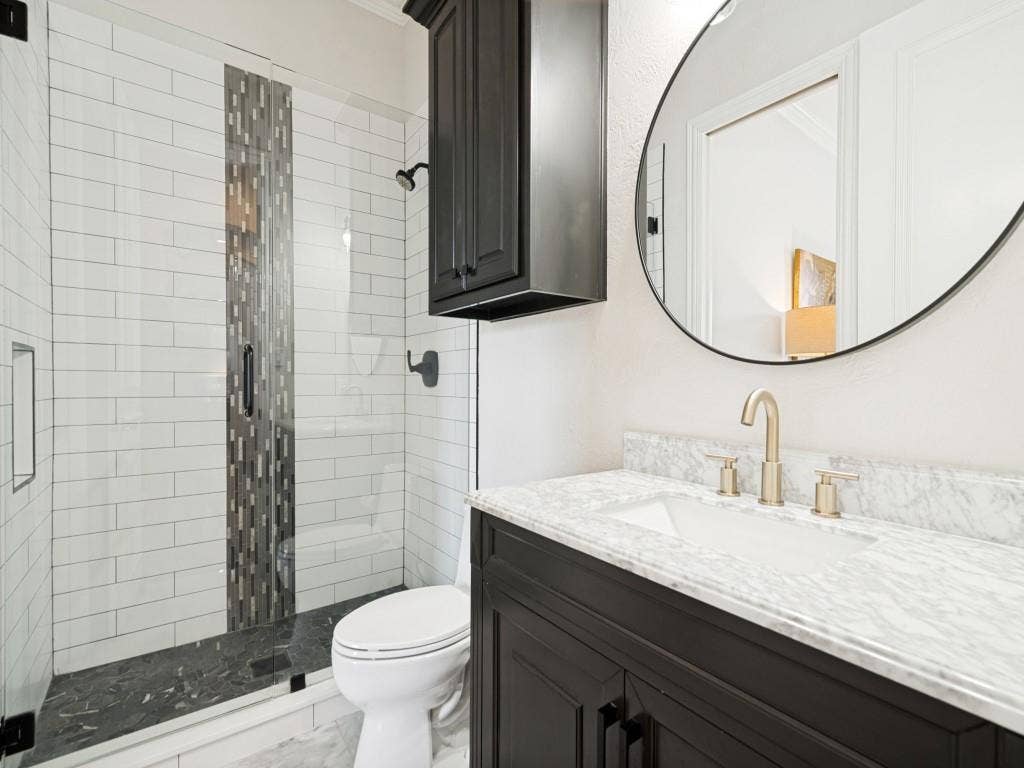 Ensuite bath to the downstairs bedroom is also accessible through a hall entry.