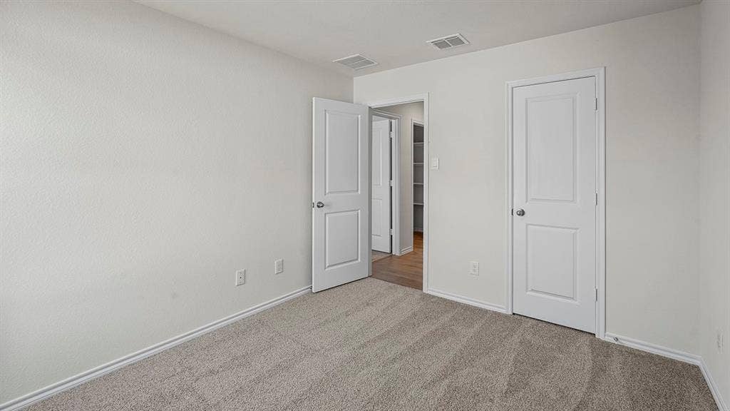215 Yates Street, Bullard, TX 75757 Neutral-toned carpeting, white walls, and white trim
