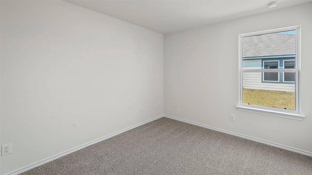 215 Yates Street, Bullard, TX 75757 Room featuring neutral wall paint, gray carpet, a single-pane window, and white trim