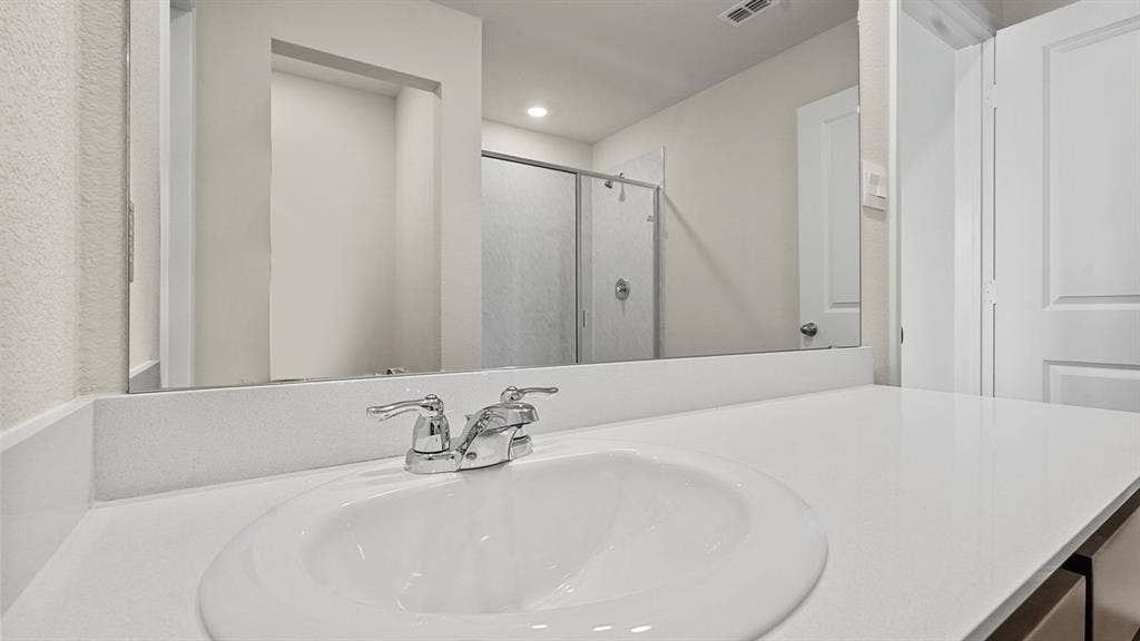 215 Yates Street, Bullard, TX 75757 White countertop with an integrated sink and chrome faucet