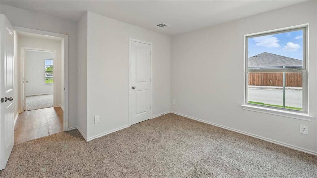 209 Yates Street, Bullard, TX 75757 Neutral wall color, carpeted flooring, white trim, white interior doors, and a double-pane window