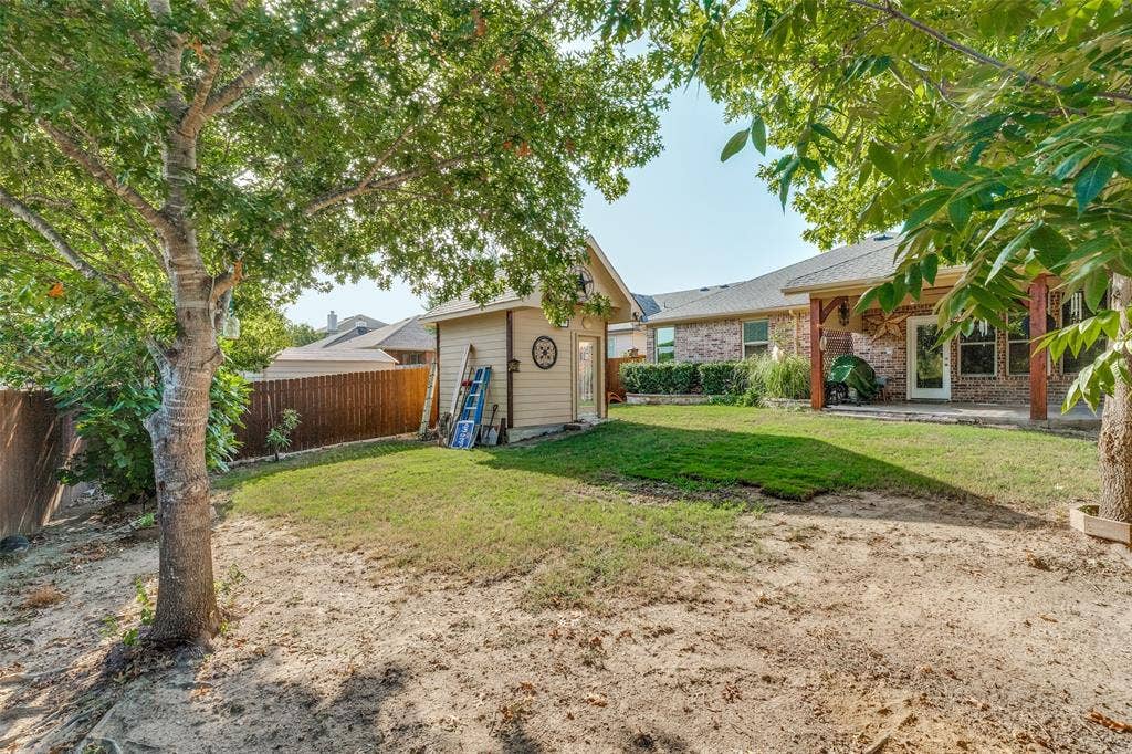 Expansive backyard featuring mature trees, a cute detached storage shed.