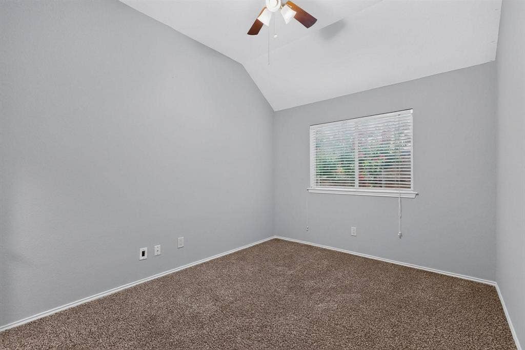 2702 Garden Springs Drive, Richardson, TX 75082 Vaulted ceiling with ceiling fan, window with blinds, and neutral carpet flooring