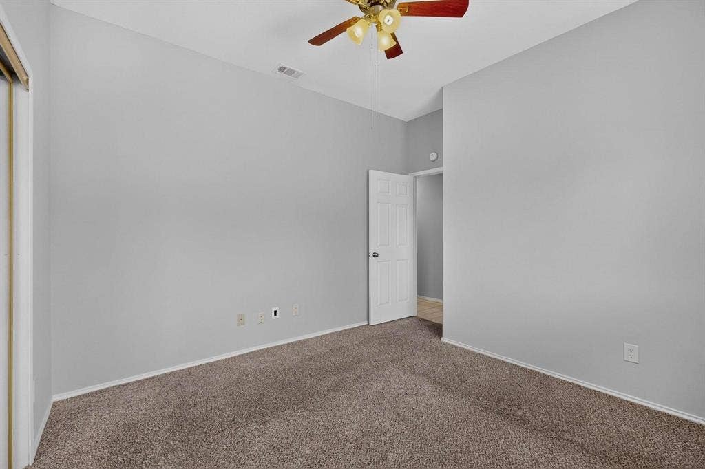 2702 Garden Springs Drive, Richardson, TX 75082 Carpeted flooring with painted walls, a ceiling fan, and a white interior door