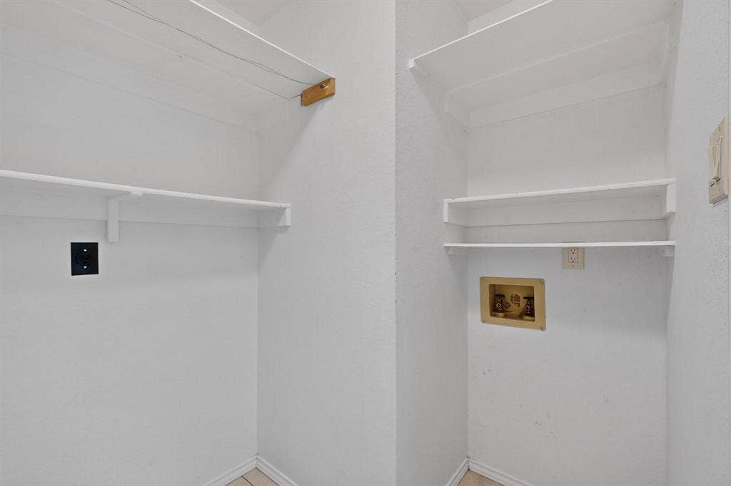 2702 Garden Springs Drive, Richardson, TX 75082 Laundry area featuring multiple storage shelves and utility hookups