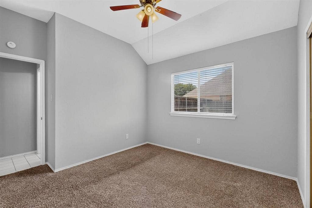 2702 Garden Springs Drive, Richardson, TX 75082 Vaulted ceiling with an attached ceiling fan, single window with blinds, and carpeted flooring