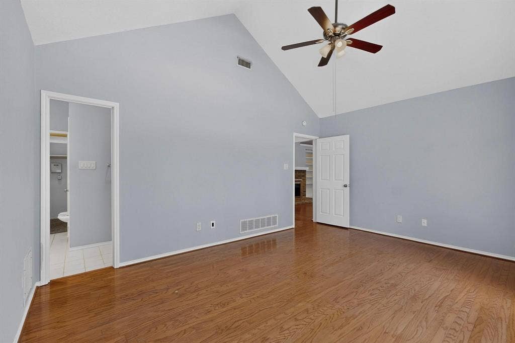 2702 Garden Springs Drive, Richardson, TX 75082 Vaulted ceiling with a ceiling fan, wood-finish flooring, and light-toned wall paint