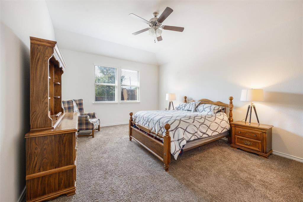 1101 Crepe Myrtle Lane, Anna, TX 75409 Vaulted ceiling with a ceiling fan, dual windows with blinds, and neutral carpet flooring