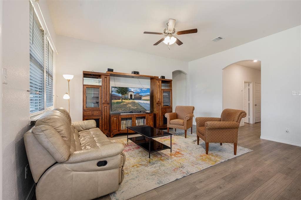 1101 Crepe Myrtle Lane, Anna, TX 75409 Spacious living area featuring wood-finish flooring, high ceilings, and a ceiling fan