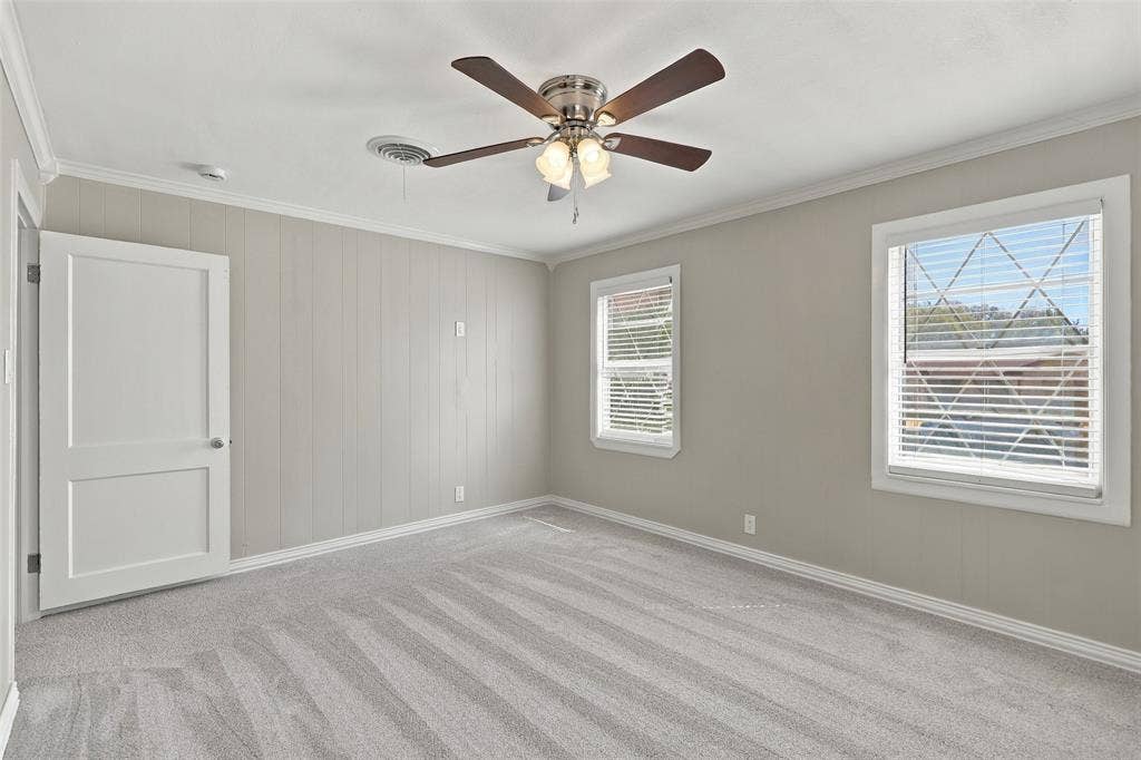605 NE 33rd Street, Grand Prairie, TX 75050 Plush carpet flooring complements pale gray walls with vertical paneling