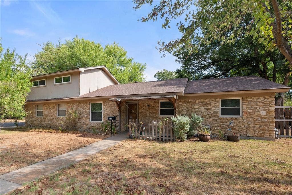 144 Jill Ann Drive, Burleson, TX 76028 Stone exterior with a shingle roof and mature trees