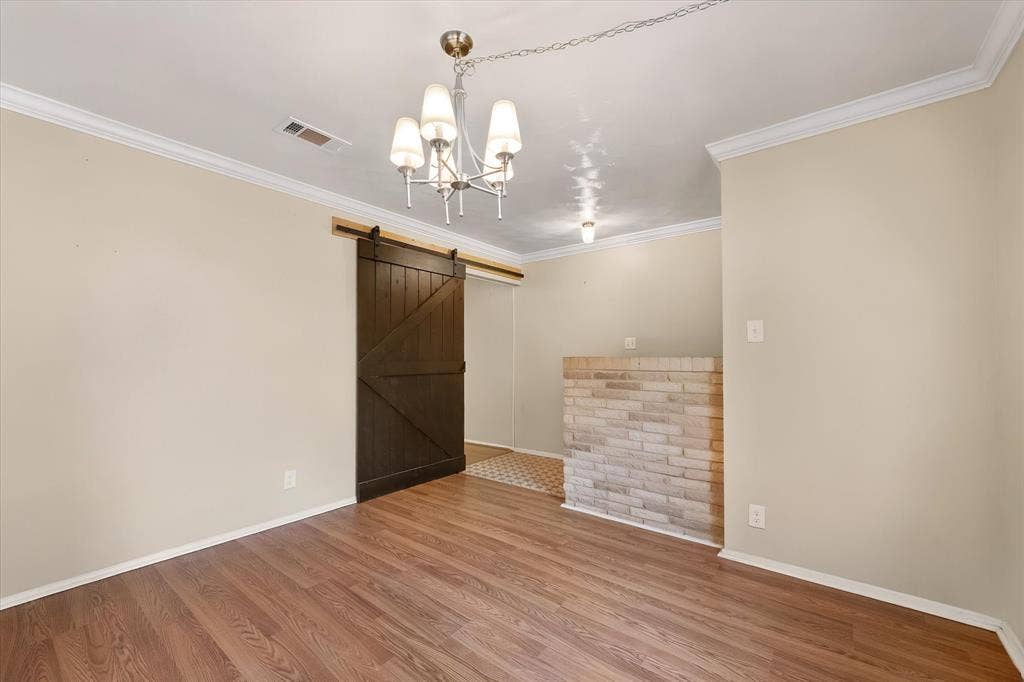 144 Jill Ann Drive, Burleson, TX 76028 Wood-finish flooring with crown molding and white baseboards