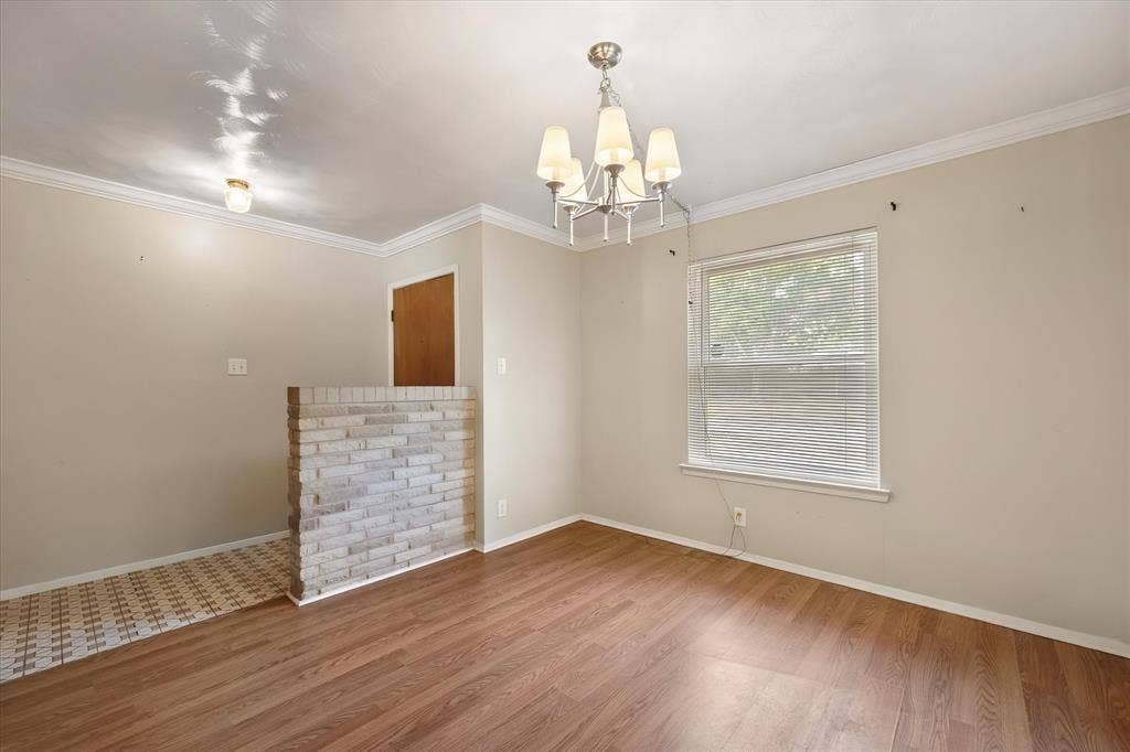 144 Jill Ann Drive, Burleson, TX 76028 Wood-finish flooring, half-height brick wall, ceiling-mounted light fixture, recessed lighting, and crown molding