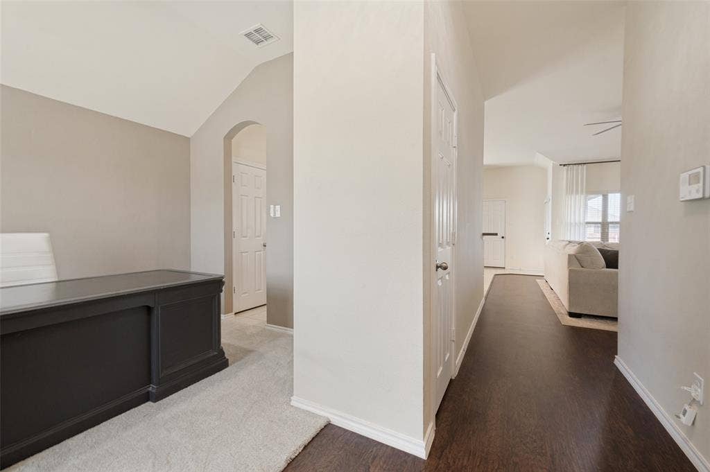 1929 Day Break Drive, Lancaster, TX 75146 Vaulted ceiling with an arched entryway, dark wood-finish flooring, and light-colored walls