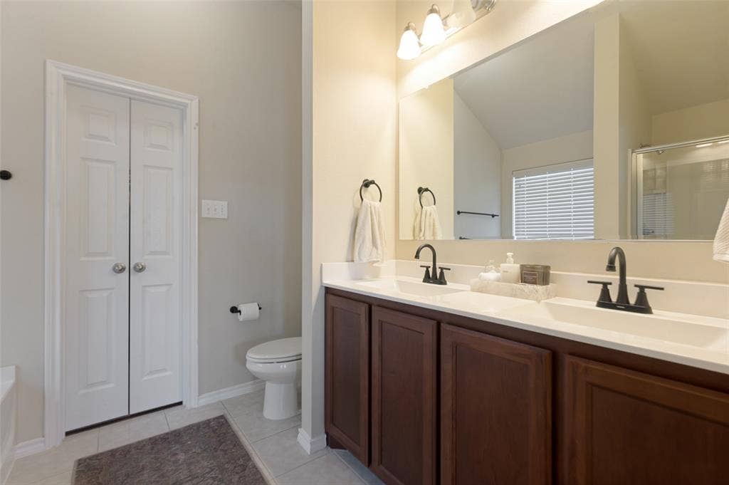 1929 Day Break Drive, Lancaster, TX 75146 Double vanity with integrated sinks, dark wood-finish cabinetry, and matte black fixtures