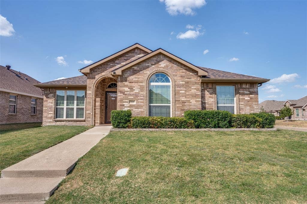 1929 Day Break Drive, Lancaster, TX 75146 Brick exterior with an arched entry and an arched window