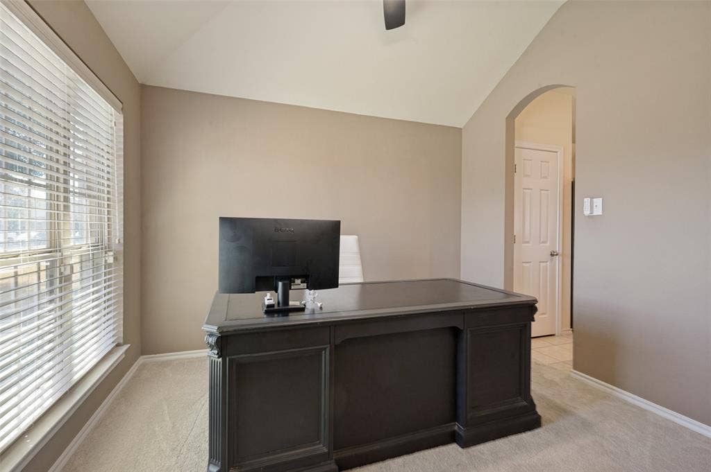 1929 Day Break Drive, Lancaster, TX 75146 Window with horizontal blinds, neutral wall paint, vaulted ceiling, and an arched doorway